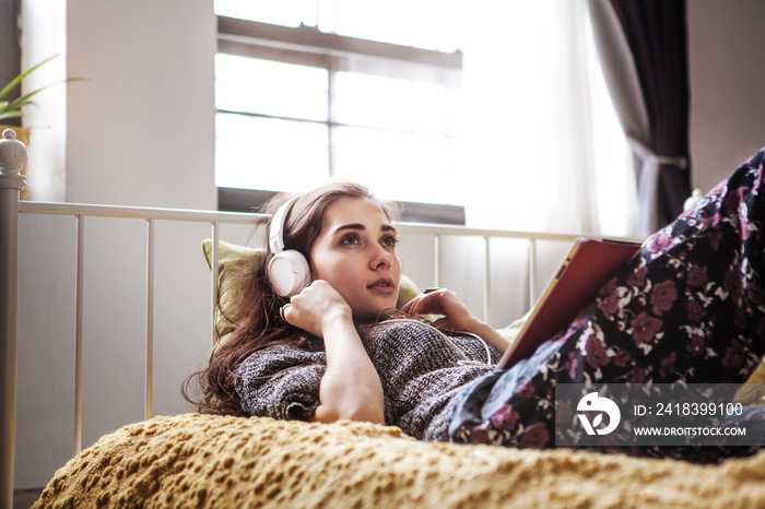 Woman listening to music in bed