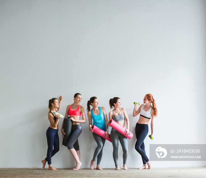 Smiling women in fitness studio.