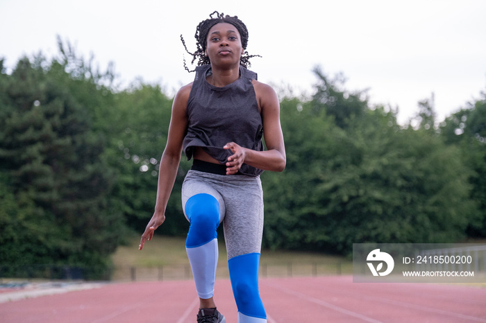 Athletic�woman running on track