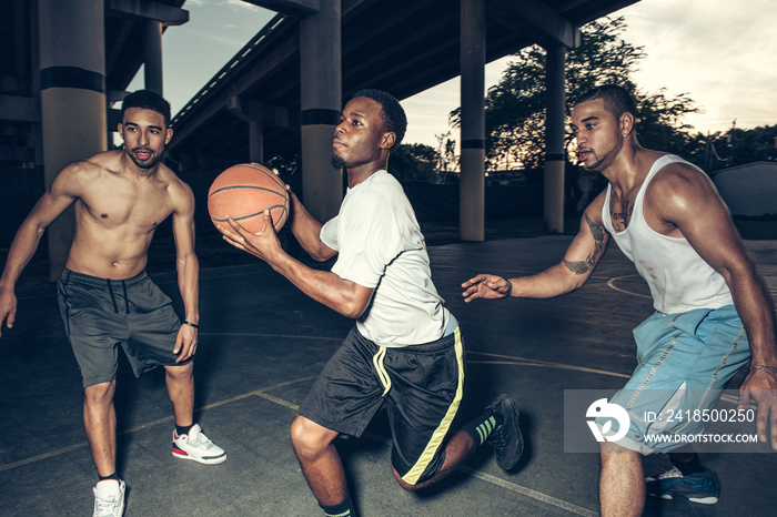 Friends on basketball court playing basketball