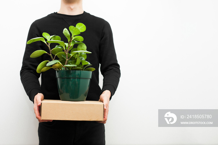 Man with box moving in a new apartament. Moving concept.