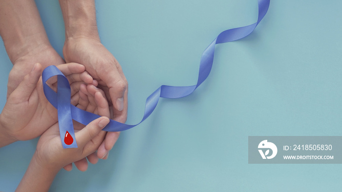 adult and child hands holding Blue ribbon with red blood, world diabetes day