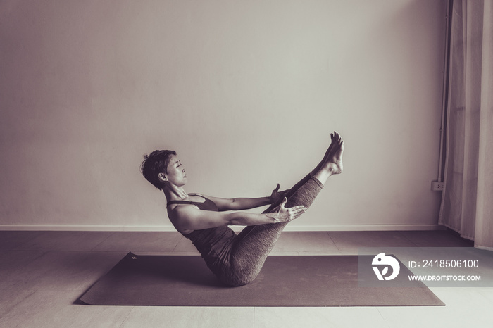 Young woman practicing yoga with namaste behind the back.working out, wearing sportswear.Calmness an