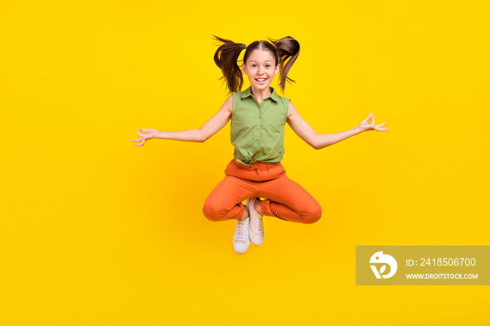 Photo of sweet funky student girl wear green shirt smiling jumping high practicing yoga isolated yel