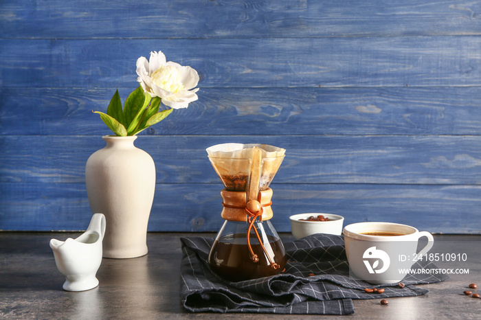 Tasty coffee in chemex on dark table