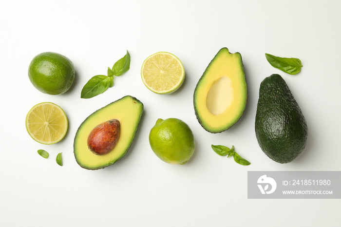 Avocado, lime and basil on white background, top view