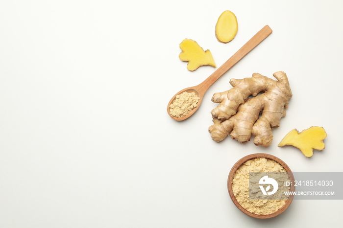 Ginger and bowl with ginger powder on white background