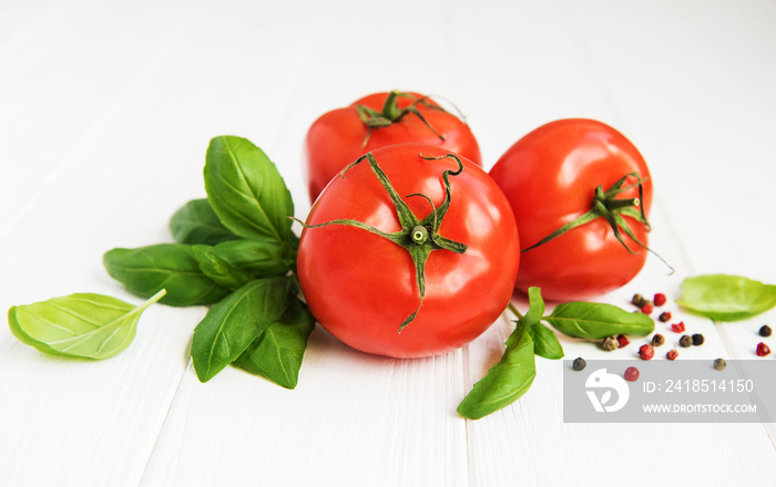 Fresh tomatoes with green basil