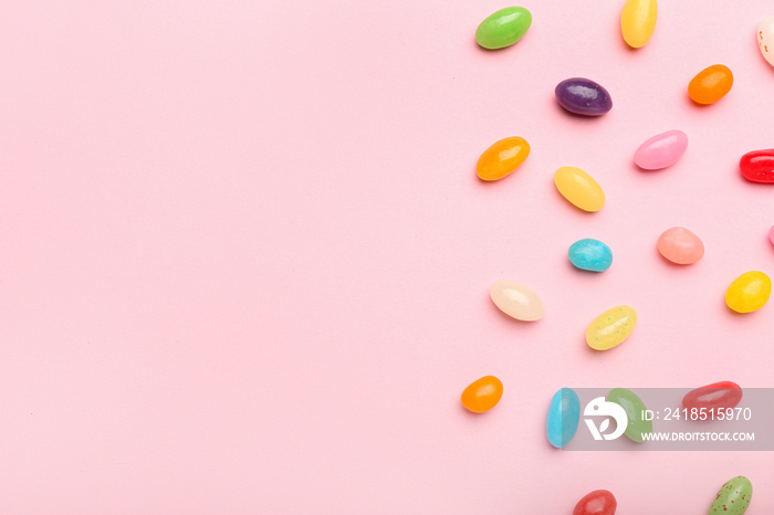 Multicolored jelly beans on color background