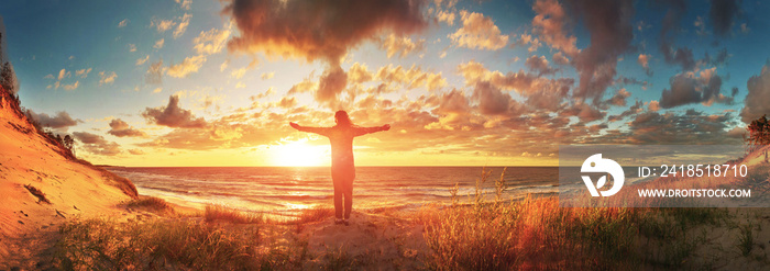 View of a happy woman on the sunset beach