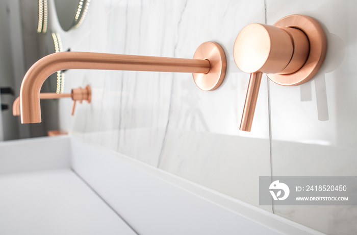 Lavish White Sink With Copper Fixtures.