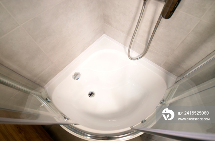 A shower cabin with a deep acrylic tray. View above.