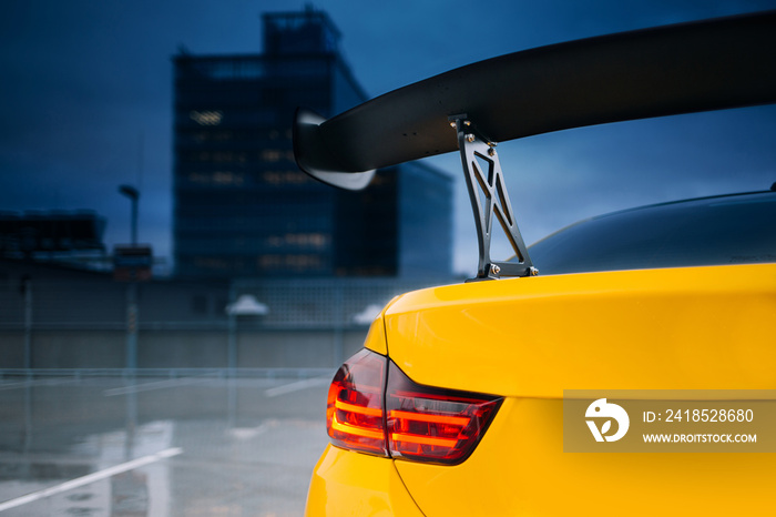 Big carbon spoiler wing on the trunk of modern supercar