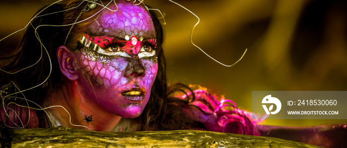 Woman in bodypaint playing on the Mangrove beach