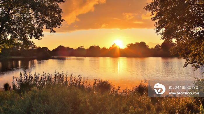 Beautiful and romantic sunset at a lake in yellow and orange colors