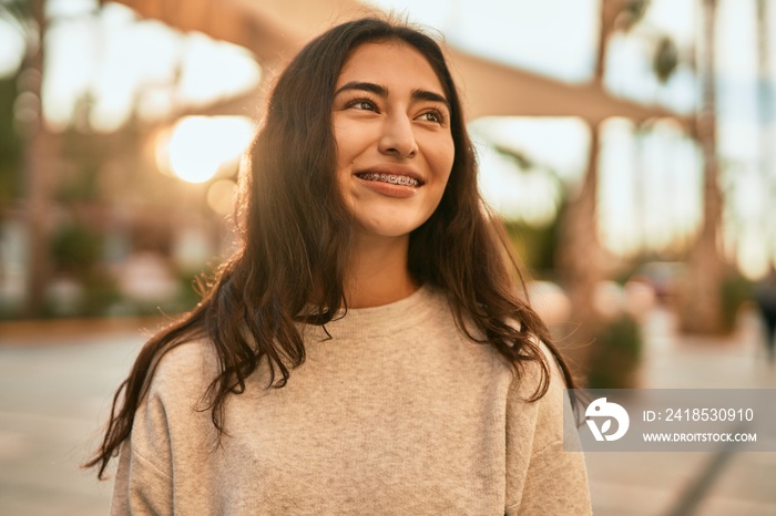 Young middle east girl smiling happy standing at the city.