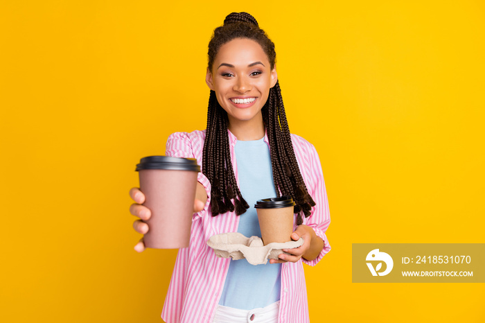 Photo of barista reliable positive lady give you coffee wear striped shirt isolated yellow color bac