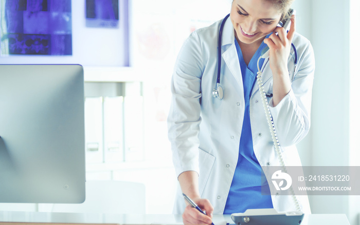 Portrait of a beautiful smiling nurse talking on the phone