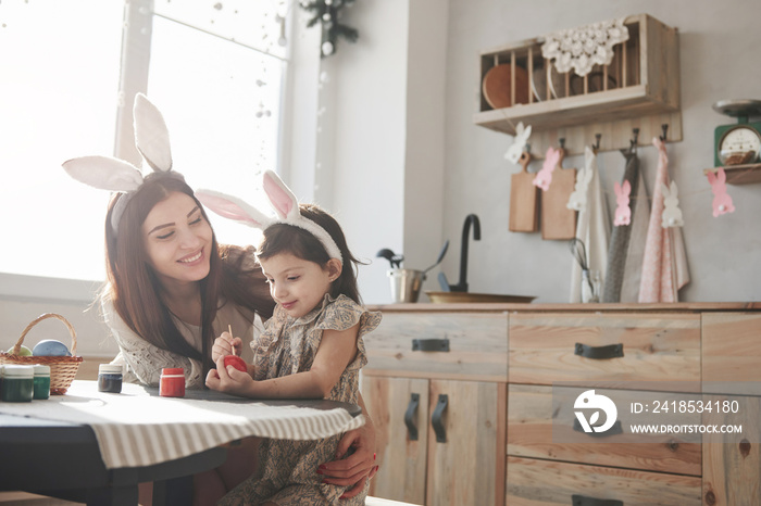 Good looking clean room. Mother and daughter in bunny ears at easter time have some fun in the kitch