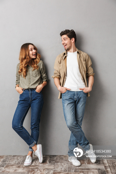 Full length portrait of a smiling young couple standing