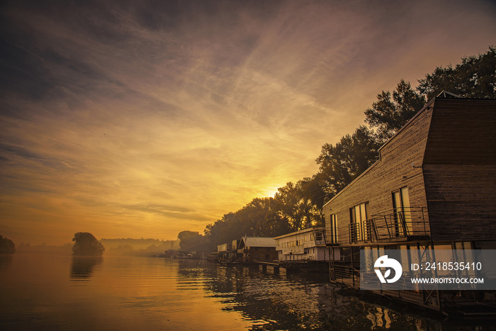 Amazing sunrise and water houses lined up on the shore of river Sava in Belgrade