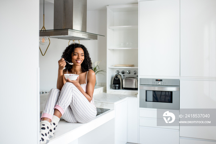 Woman having breakfast with mobile phone