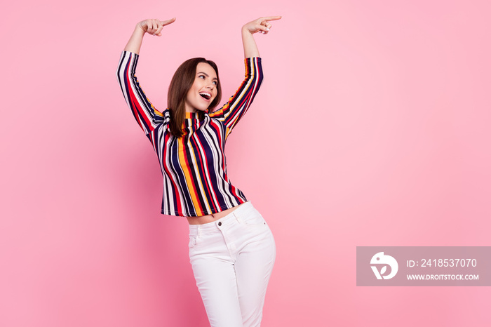 Photo of sweet cute young woman dressed colorful blouse smiling dancing pointing empty space isolate