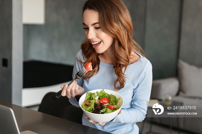 Portrait of a happy young woman eating