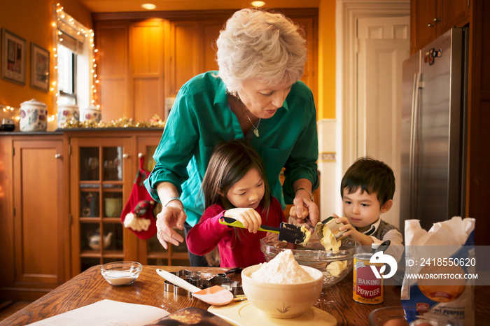 Grandmother baking with grandchildren (12-17 months,  4-5)