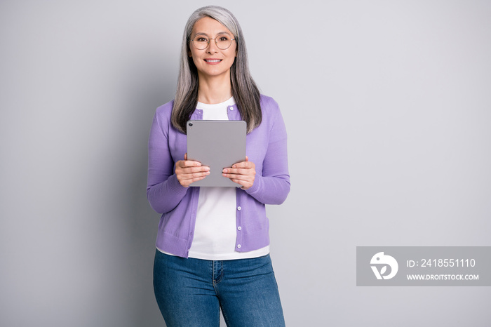 Portrait photo of elder businesswoman working with tablet using modern technoligies texting wearing 