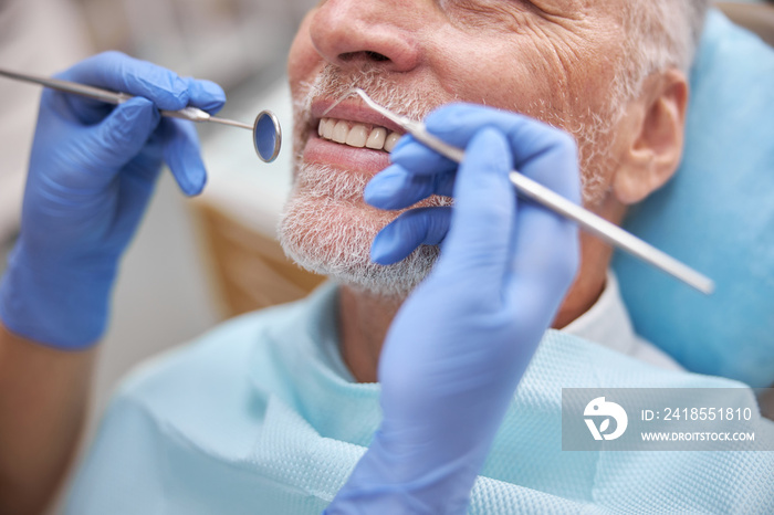 Eldelry man smiling during a dental appointment