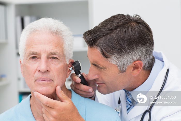 医生用耳镜检查老年患者的耳朵