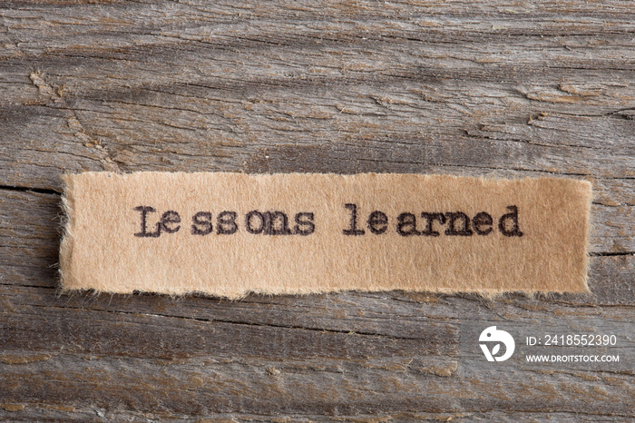 lessons learned - word on a piece of paper close up, business creative motivation concept