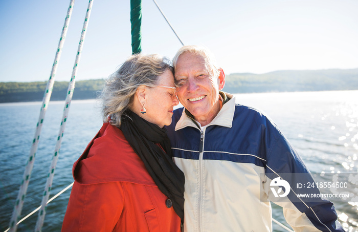 Smiling senior couple on sailboat