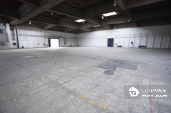 large empty factory space with concrete floor