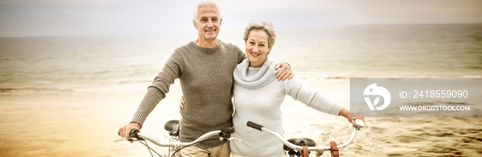 Happy senior couple with their bike