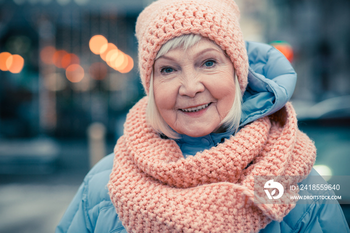 Portrait of happy aged woman in winter clothes