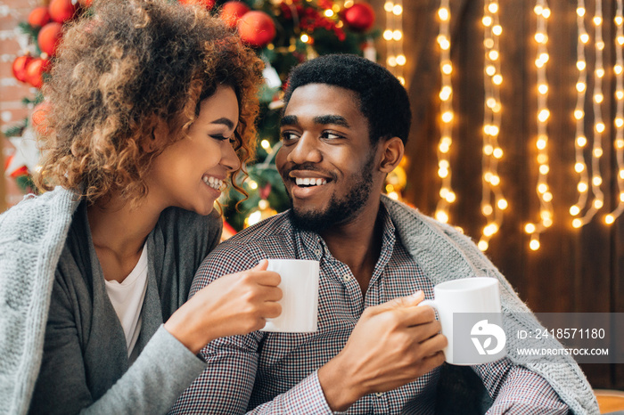 Young couple drinking coffee and enjoying Christmas morning