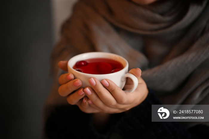 Young woman drinking tea in cafe, closeup