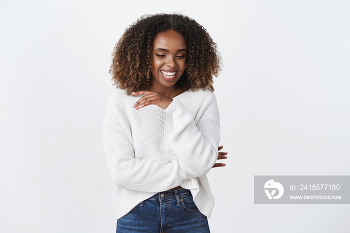 Carefree amused positive african american curly-haired woman white sweater laughing out loud joyfull