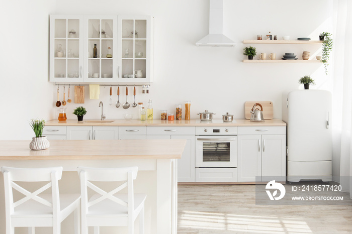 Dining room and kitchen interior. Plant on wooden table with white chairs, kitchenware and utensils 