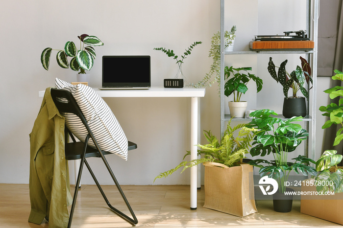 Home office decorate with green nature tree plants, Workspace and laptop computer on desk, Artificia