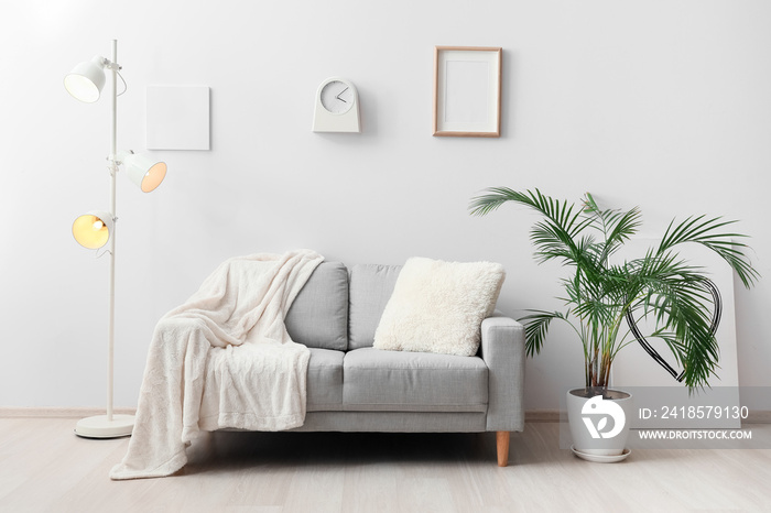 Stylish sofa in interior of living room