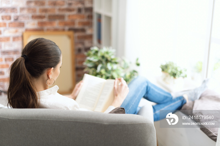 Woman relaxing and reading a book