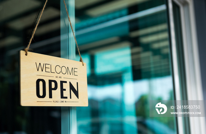 Label Welcome We are OPEN Welcome in notice sign wood board hanging on door front coffee shop.