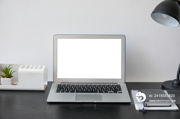 Comfortable workplace with modern laptop in office