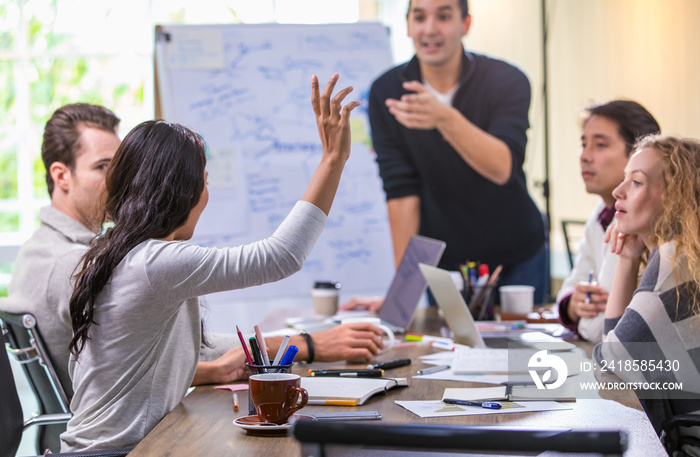 Selective focus Caucasian professional modern hipster businesswoman presenting and raising hand to q