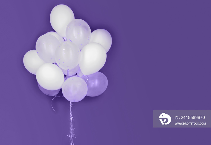 white helium balloons on ultra violet background