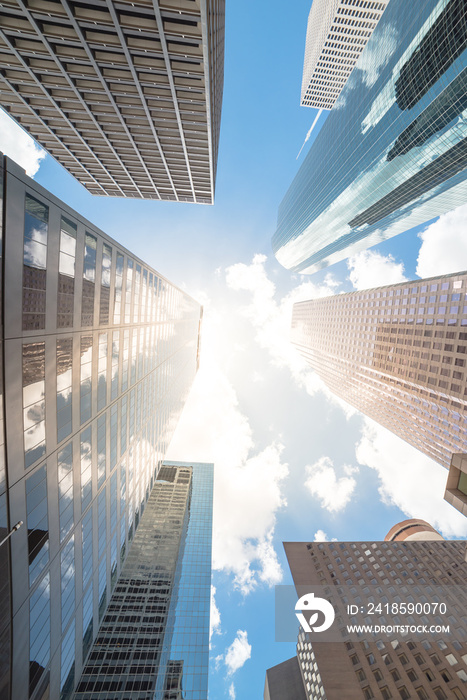 Upward view of skyscrapers against a cloud blue sky in the business district area of downtown Housto