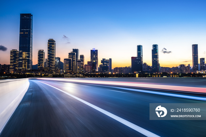 empty asphalt road with city skyline